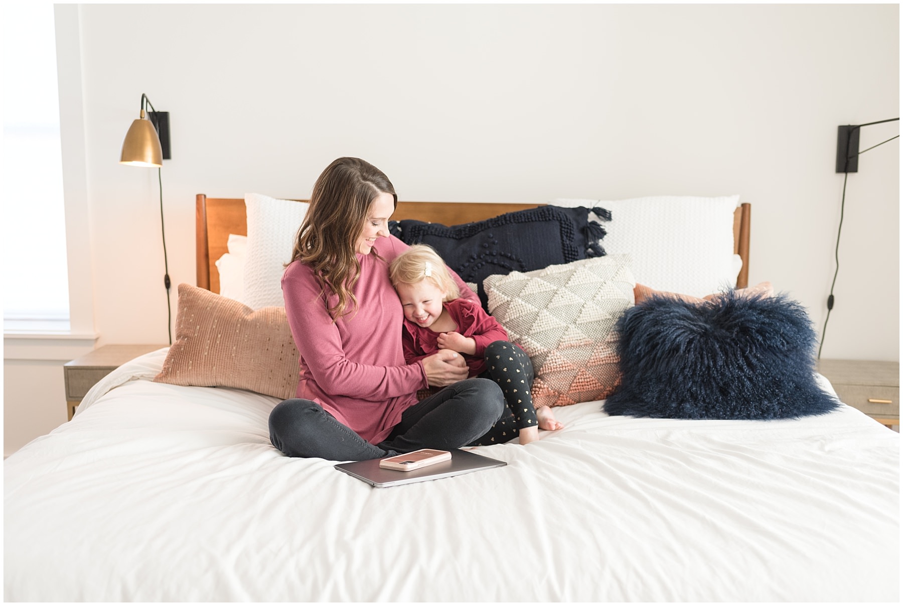 Lifestyle brand picture of Gotcha Mama podcast host snuggling her daughter in bed